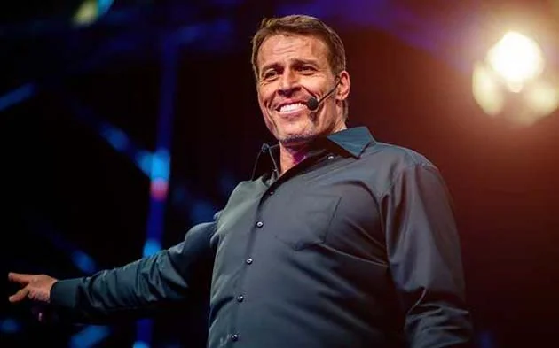 Tony Robbins speaking at a seminar with his supplement routine overlay