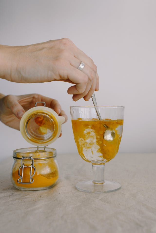 Chris Bumstead adding turmeric to his drink