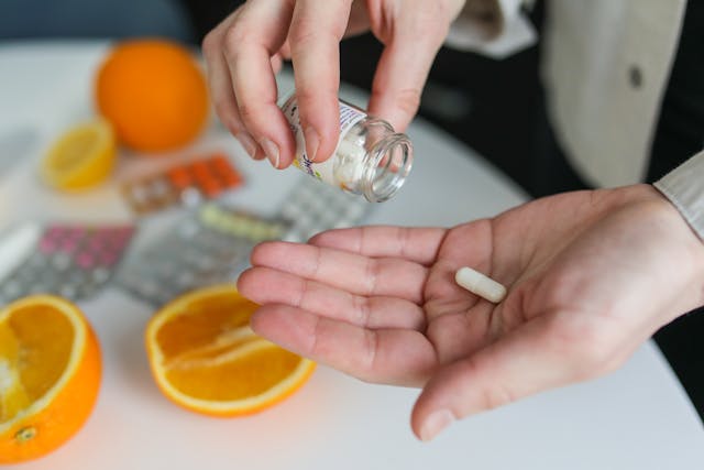 Chris Bumstead holding his vitamin C pills