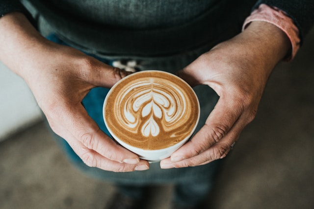 Gary Brecka holding a coffee cup