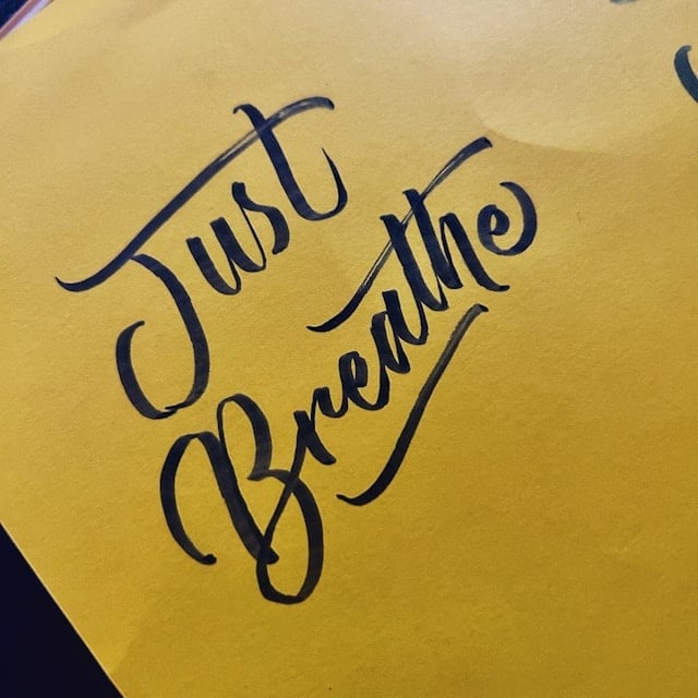 'Just Breathe' written on a a wall