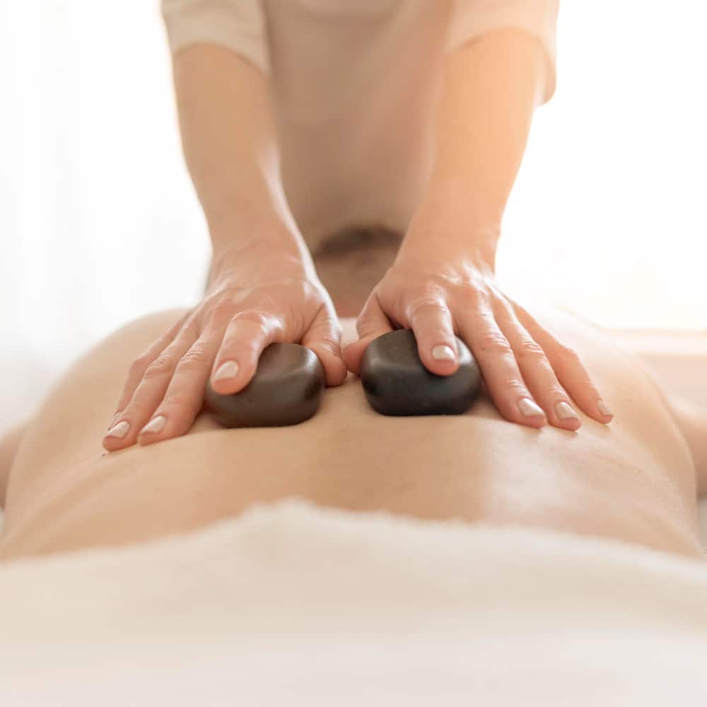 An individual focusing on body Gua Sha